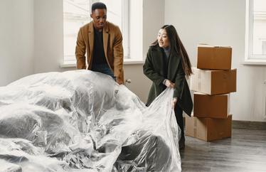 homeowners unpacking belonging while moving into a new home